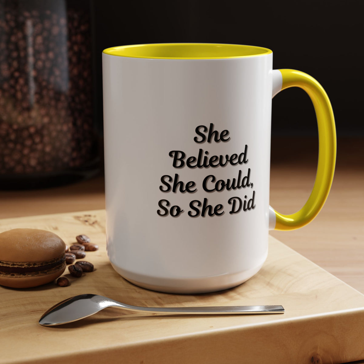 White ceramic motivational coffee mug with black text reading "She Believed She Could, So She Did" from Printify.