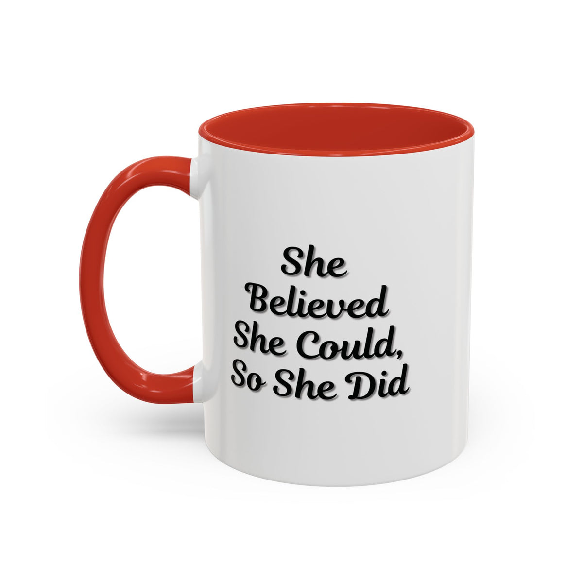 White ceramic motivational coffee mug with black text reading "She Believed She Could, So She Did" displayed on a plain background.