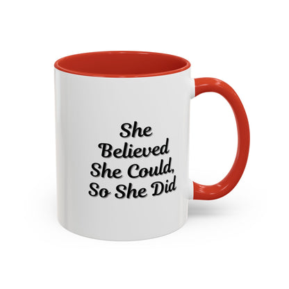 White ceramic motivational coffee mug with black text reading "She Believed She Could, So She Did" for daily inspiration.