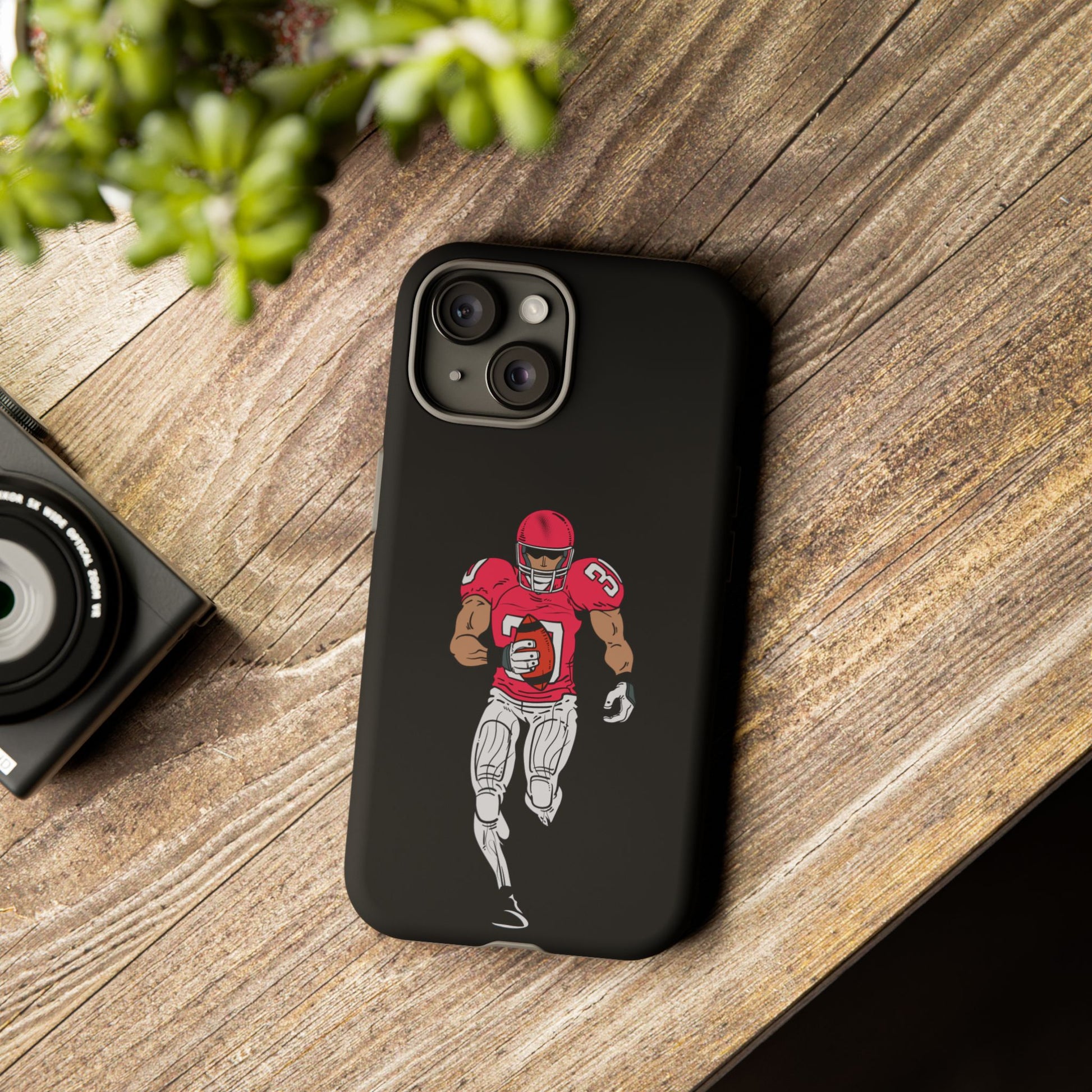 Black football player tough phone case for iPhone, protective sports-themed case by Printify featuring athletic design.