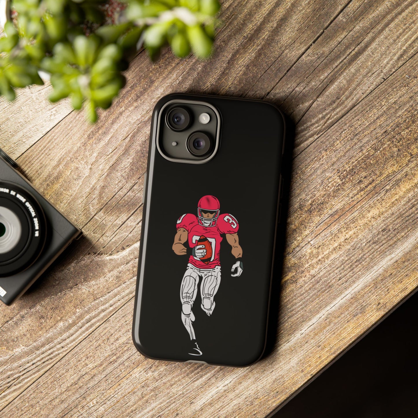 Black football player tough phone case for iPhone, durable sports-themed protective case by Printify showing athletic design.