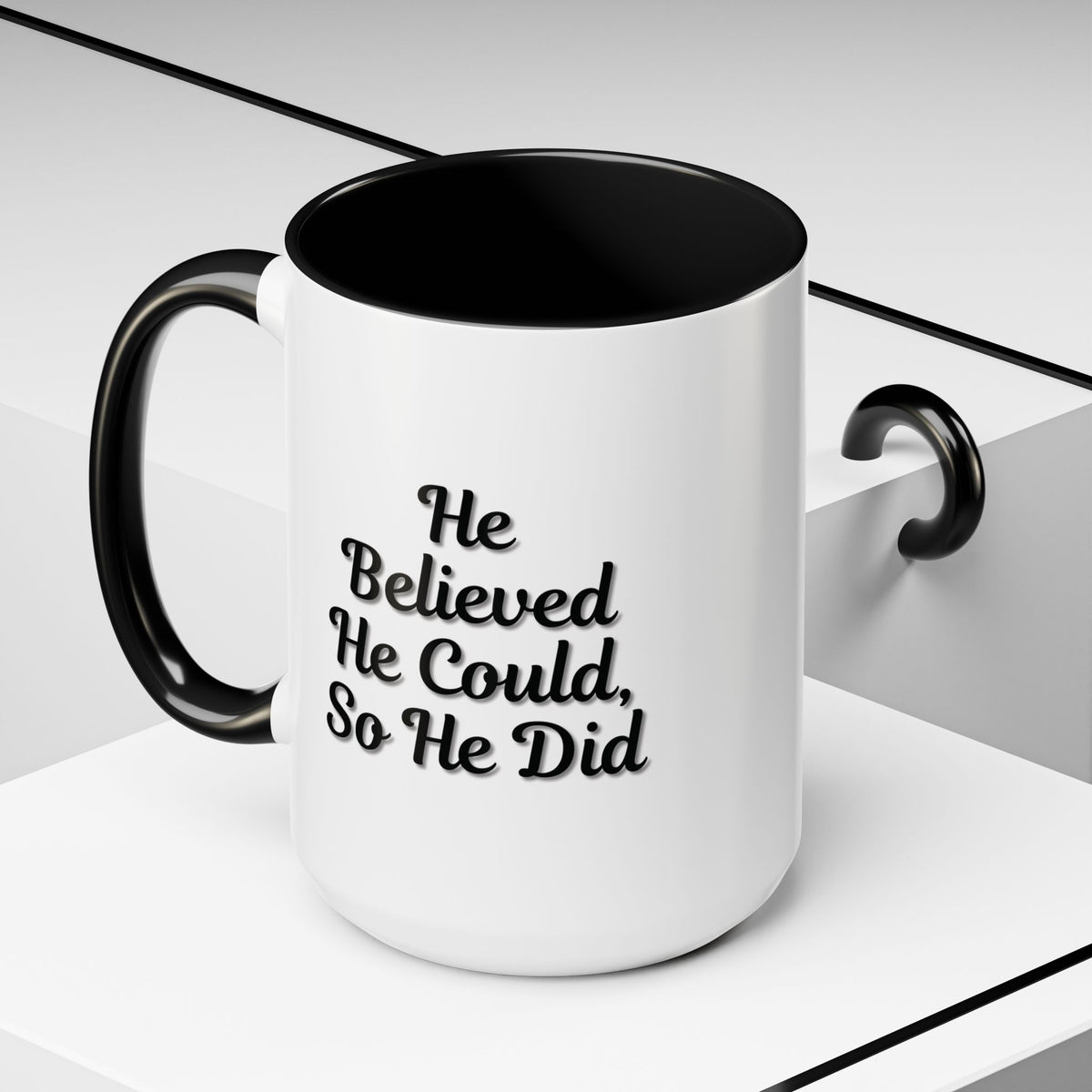Printify "He Believed He Could So He Did" inspirational coffee mug with bold black text on a white ceramic mug.