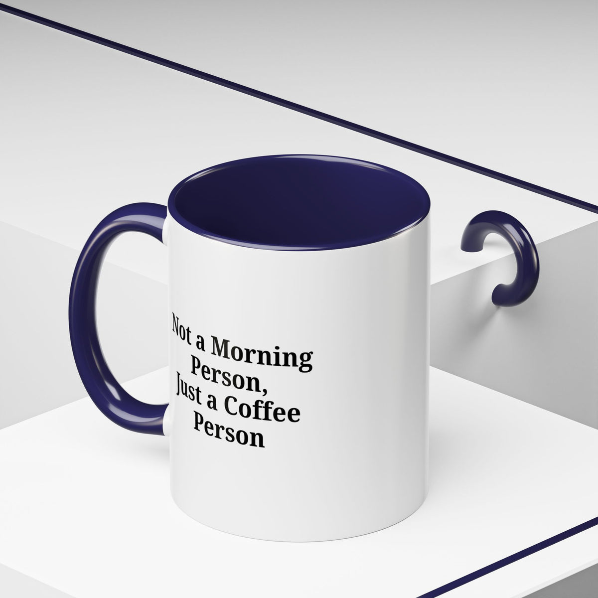 Ceramic coffee mug with "Not a Morning Person, Just a Coffee Person" text, featuring a white background and colorful lettering.