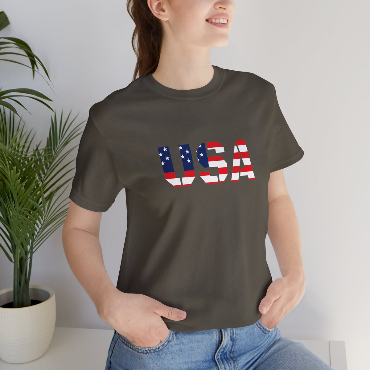 USA Flag Text T-Shirt by Printify featuring patriotic red, white, and blue design for Fourth of July celebrations.
