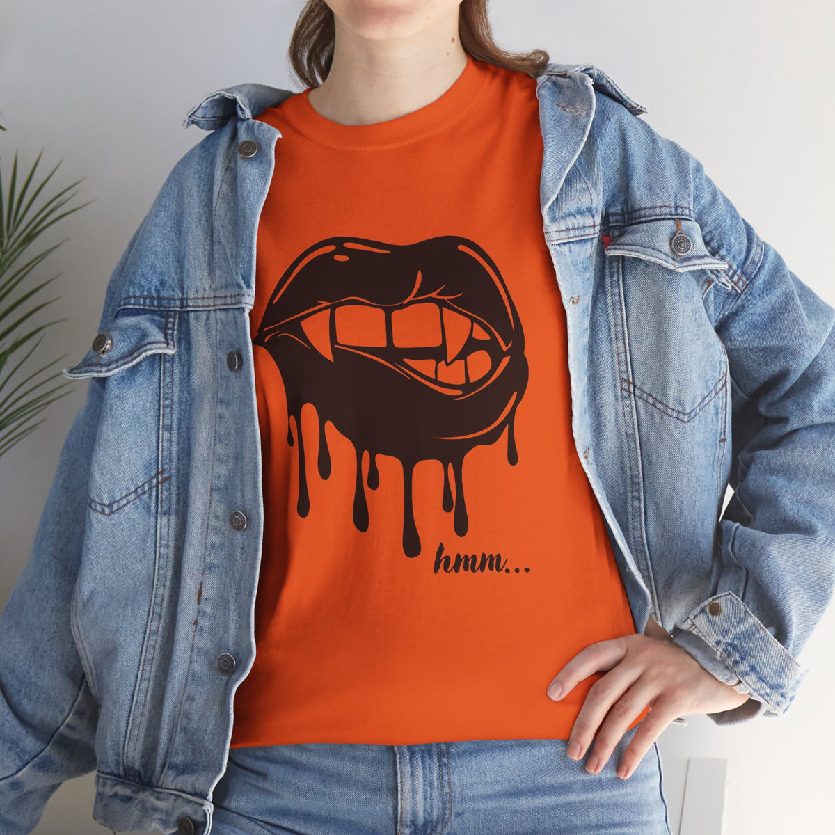 Black graphic T-shirt by Printify featuring dripping lips with a 'hmm...' bite design on the front.