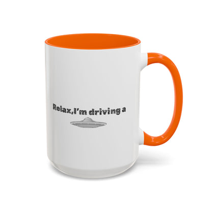 Ceramic coffee mug with UFO accent and "Relax, I’m Driving" text in black on white, 11 or 15 oz size.
