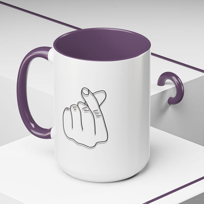 White ceramic coffee mug with minimal Korean finger heart accent design, available in 11oz and 15oz sizes.