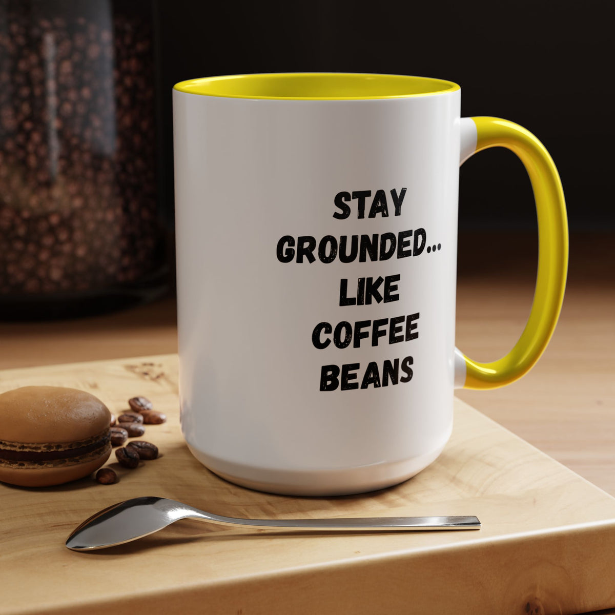 Black ceramic mug featuring "Stay Grounded Like Coffee Beans" quote, perfect for coffee lovers, 11oz size.