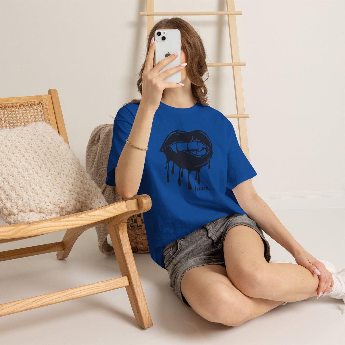 Graphic T-shirt by Printify featuring a dripping lips 'hmm...' bite design on a black cotton tee.