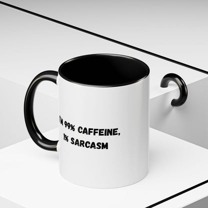 Ceramic coffee mug with "I'm 99% Caffeine, 1% Sarcasm" print, featuring a white background and colorful text design.