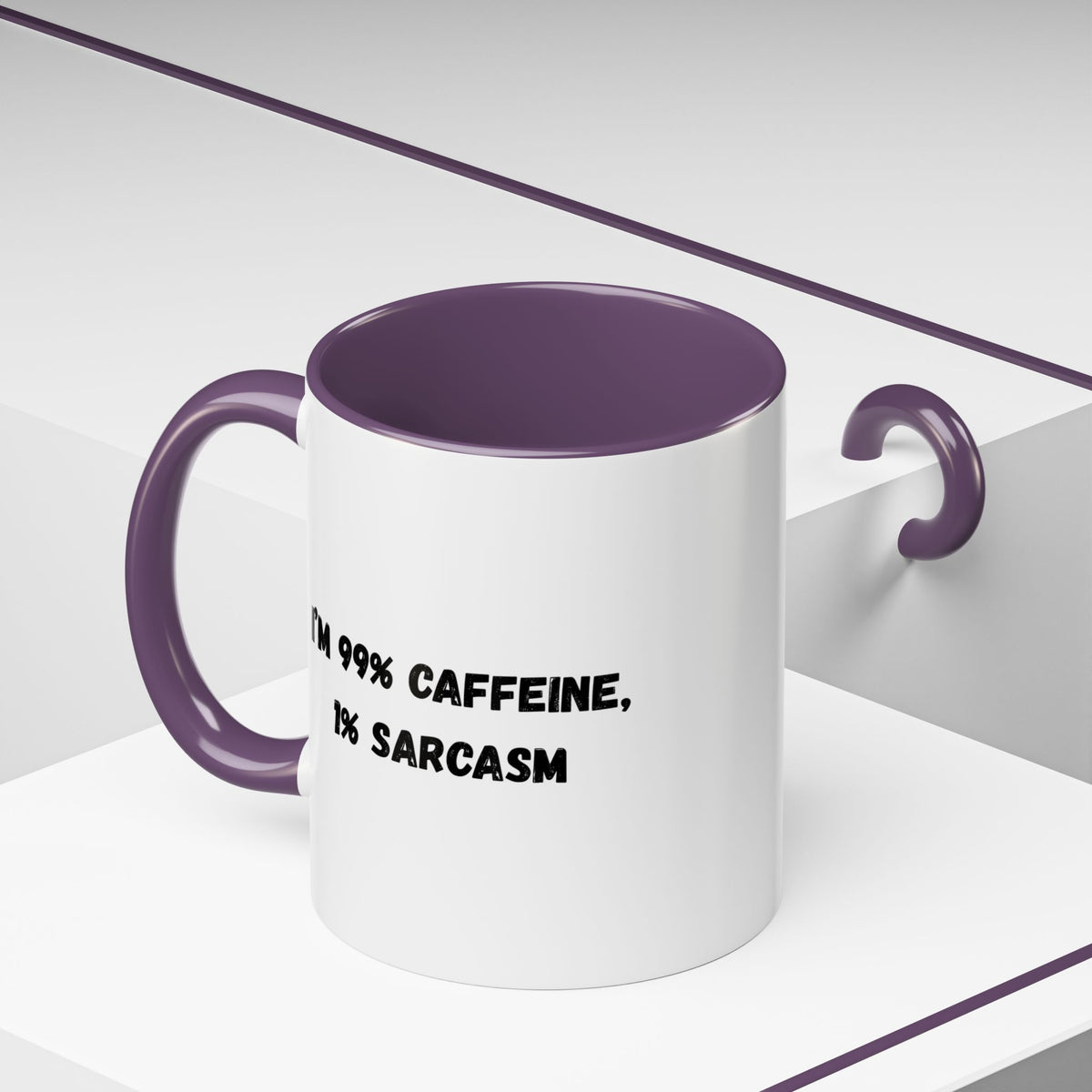 Ceramic coffee mug with "I'm 99% Caffeine, 1% Sarcasm" print, accent design, ideal for coffee lovers.