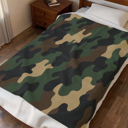 Camouflage velveteen plush blanket with all-over print, soft camo throw for camping, hunting, or cozy home use.