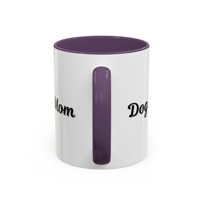 Dog Mom Accent Coffee Mug — white ceramic coffee mug with retro script "Dog Mom" print, colored interior and C-handle, 11oz/15oz, angled view on wooden table