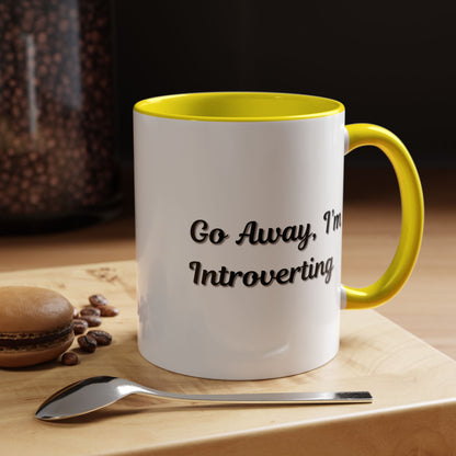 Ceramic introvert coffee mug with "Go Away, I'm Introverting" quote, 11 oz capacity, featuring a white background and black text.
