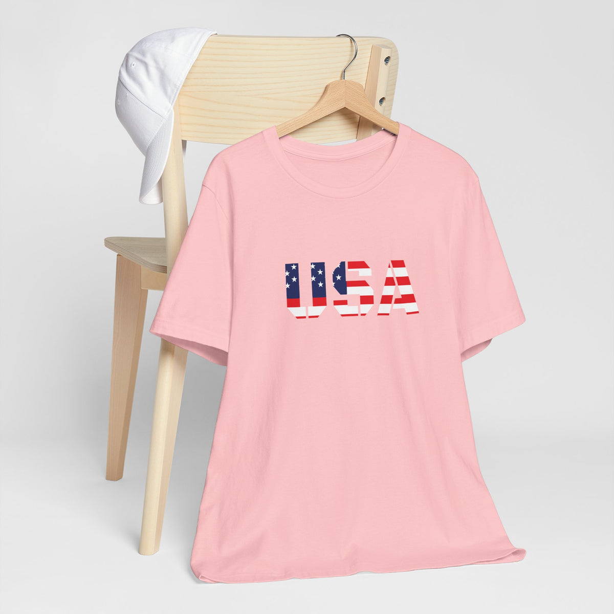 USA flag printed text T-shirt by Printify, patriotic Fourth of July T-shirt with bold red, white, and blue design.