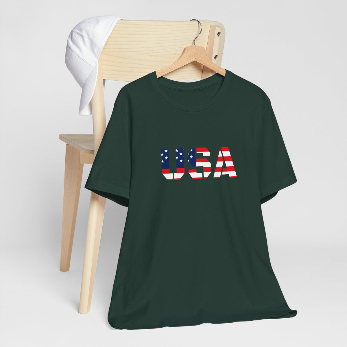 USA Flag Text T-shirt by Printify featuring patriotic red, white, and blue colors for Fourth of July celebrations.