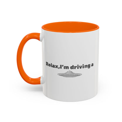 Ceramic coffee mug with "Relax, I’m Driving" UFO accent design in 11 oz size, featuring a colorful alien motif.