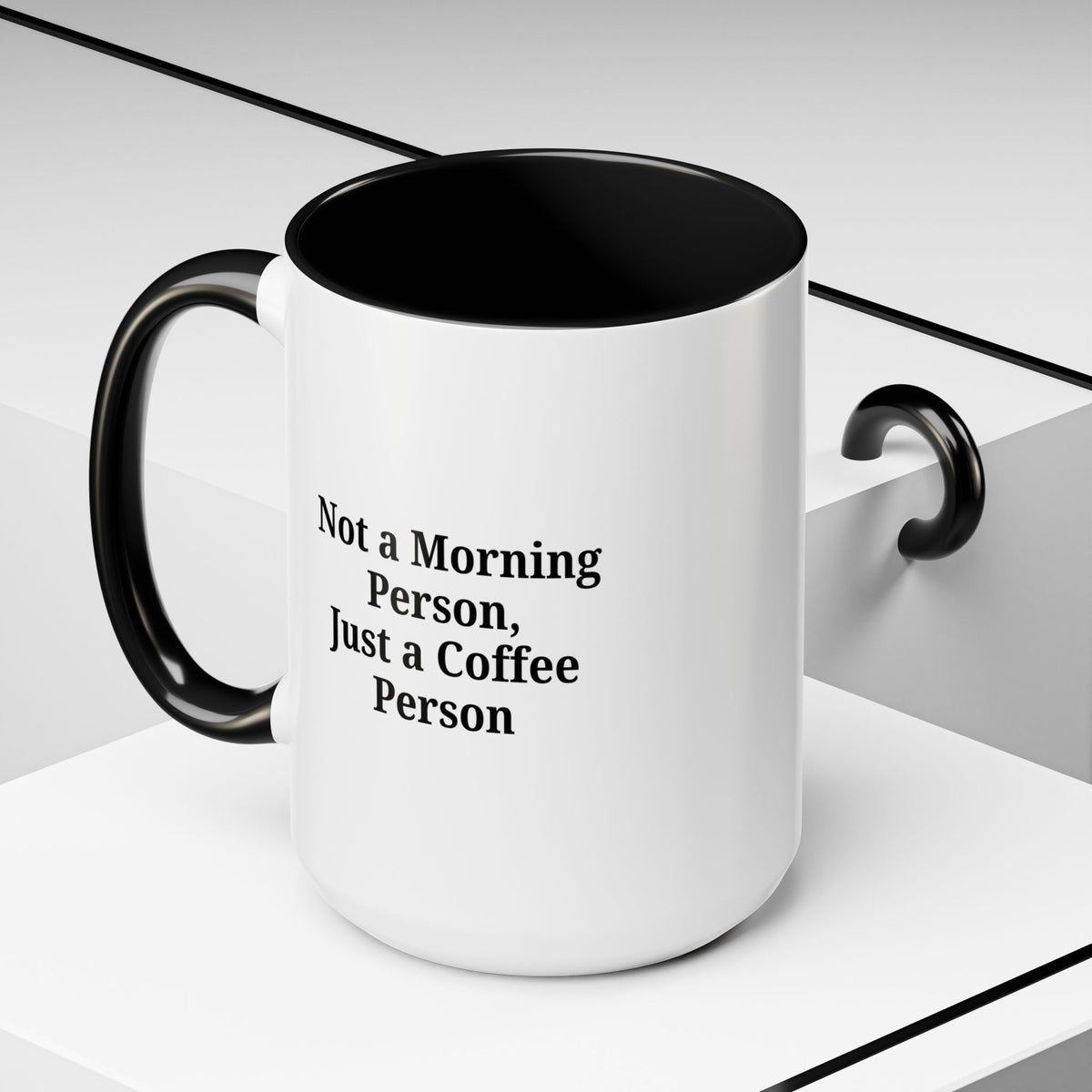 Ceramic coffee mug with "Not a Morning Person, Just a Coffee Person" text, featuring a white background and colorful lettering.