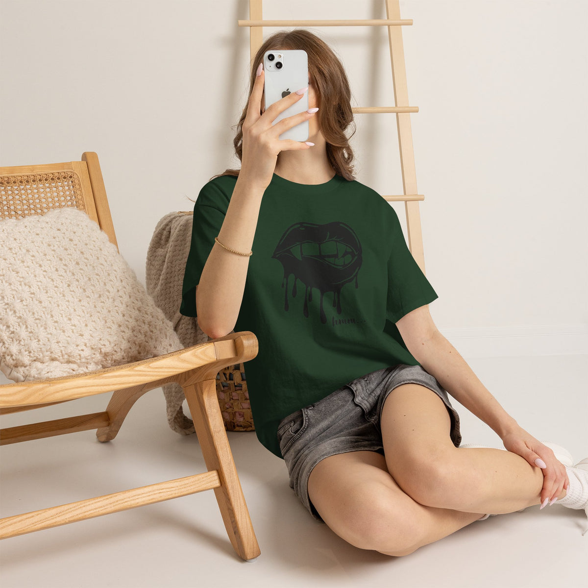 Black graphic T-shirt with dripping lips and "hmm..." bite design by Printify, showcasing the bold, artistic print on the front.