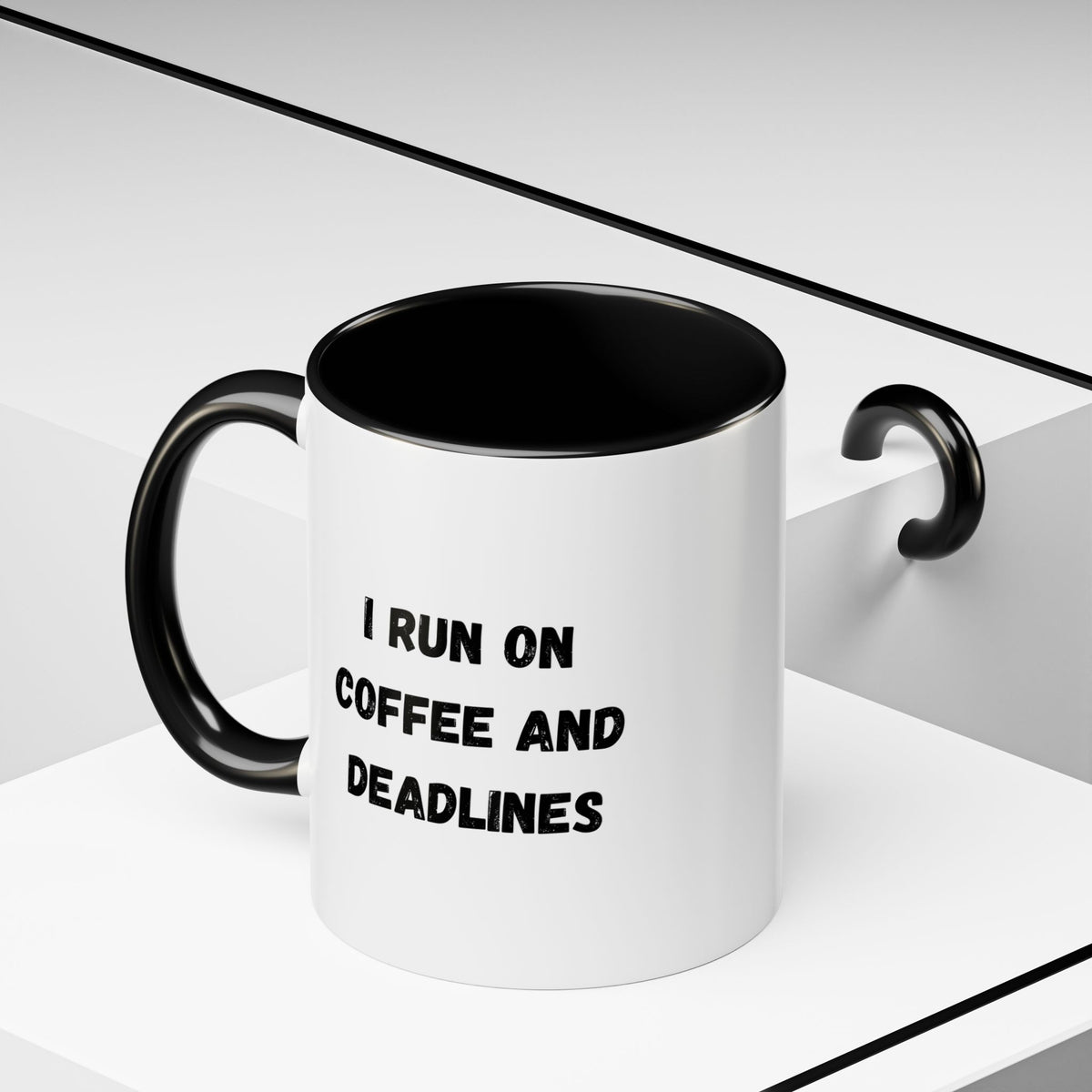White ceramic coffee mug with black text reading "I Run on Coffee and Deadlines" from Printify, shown from a side angle.
