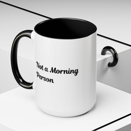 Ceramic coffee mug with "Not a Morning Person" print, 11oz size, ideal for morning beverage enjoyment and daily use.