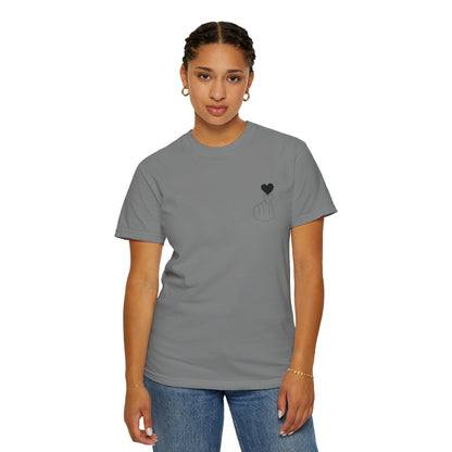 Black T-shirt with a minimal finger heart graphic design, by Printify, featuring a subtle black heart on the front.