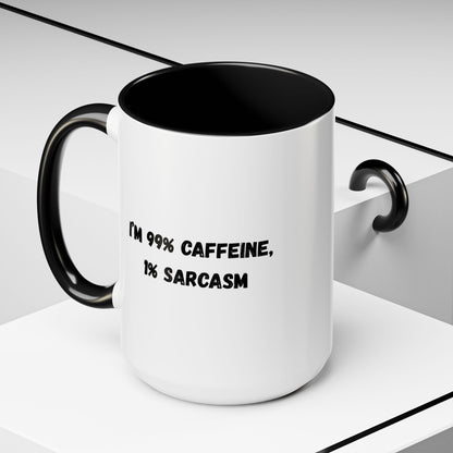 Ceramic coffee mug with "I'm 99% Caffeine, 1% Sarcasm" print, featuring a white background and colorful text design.
