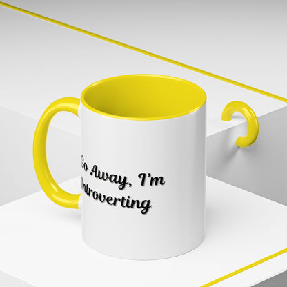 Ceramic coffee mug with "Go Away, I'm Introverting" slogan, 11 oz size, featuring a white mug with black text.
