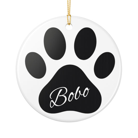 Black paw print ceramic ornament with pet's name, ideal as a memorial Christmas decoration from Printify.