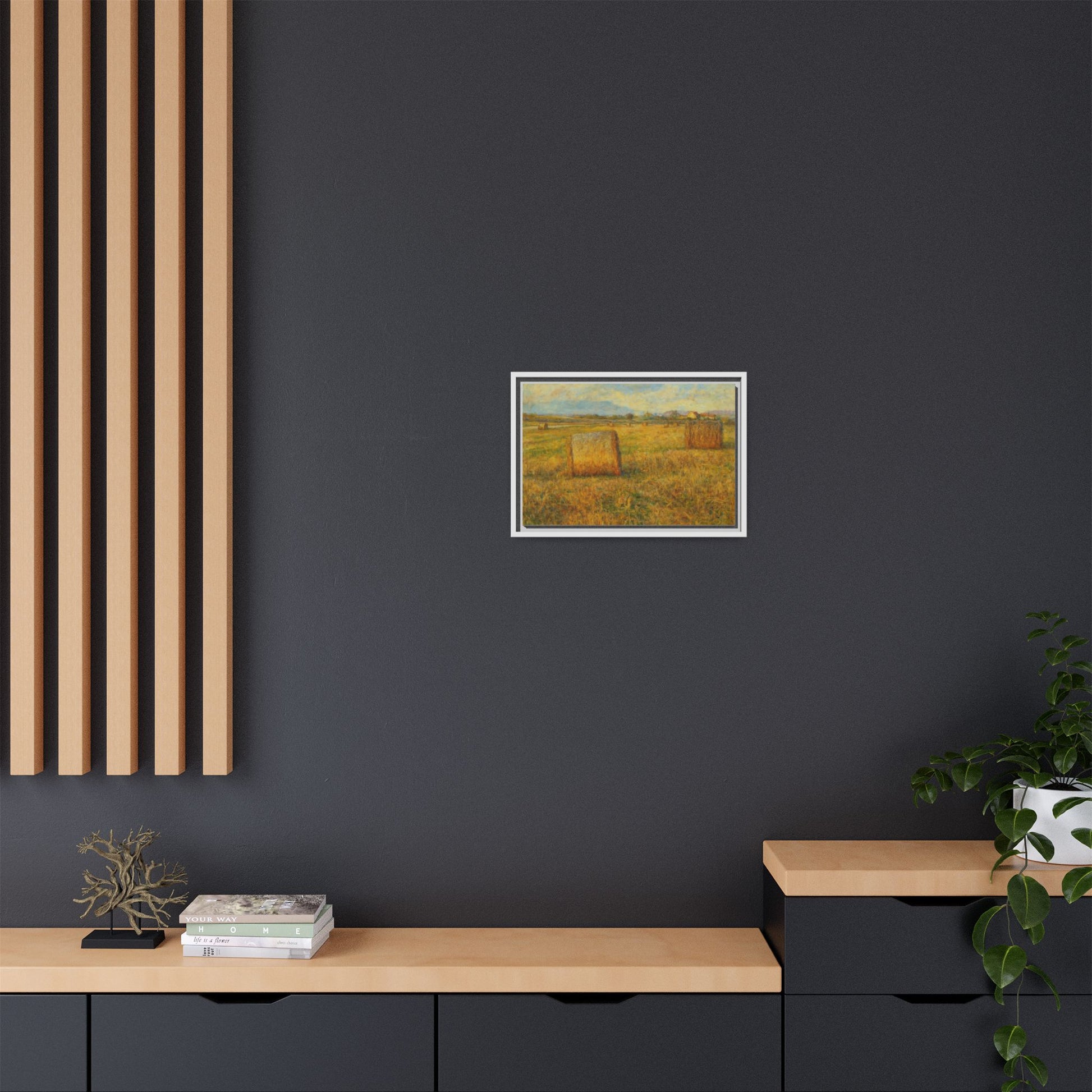 Framed matte canvas wall art of a rustic hayfield landscape print by Printify, showing a peaceful rural scene with vibrant colors.