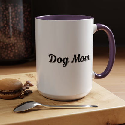 Dog Mom Accent Coffee Mug — white ceramic coffee mug with retro script "Dog Mom" print, colored interior and C-handle, 11oz/15oz, angled view on wooden table