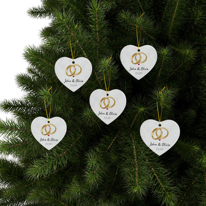 Round ceramic wedding rings ornament with personalized names and date, featuring a decorative design for special occasions.