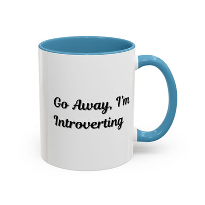 Ceramic coffee mug with "Go Away, I'm Introverting" text, 11 oz, featuring a white background and black lettering.