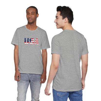USA flag text T-shirt by Printify featuring patriotic Fourth of July design, with red, white, and blue colors on cotton fabric.
