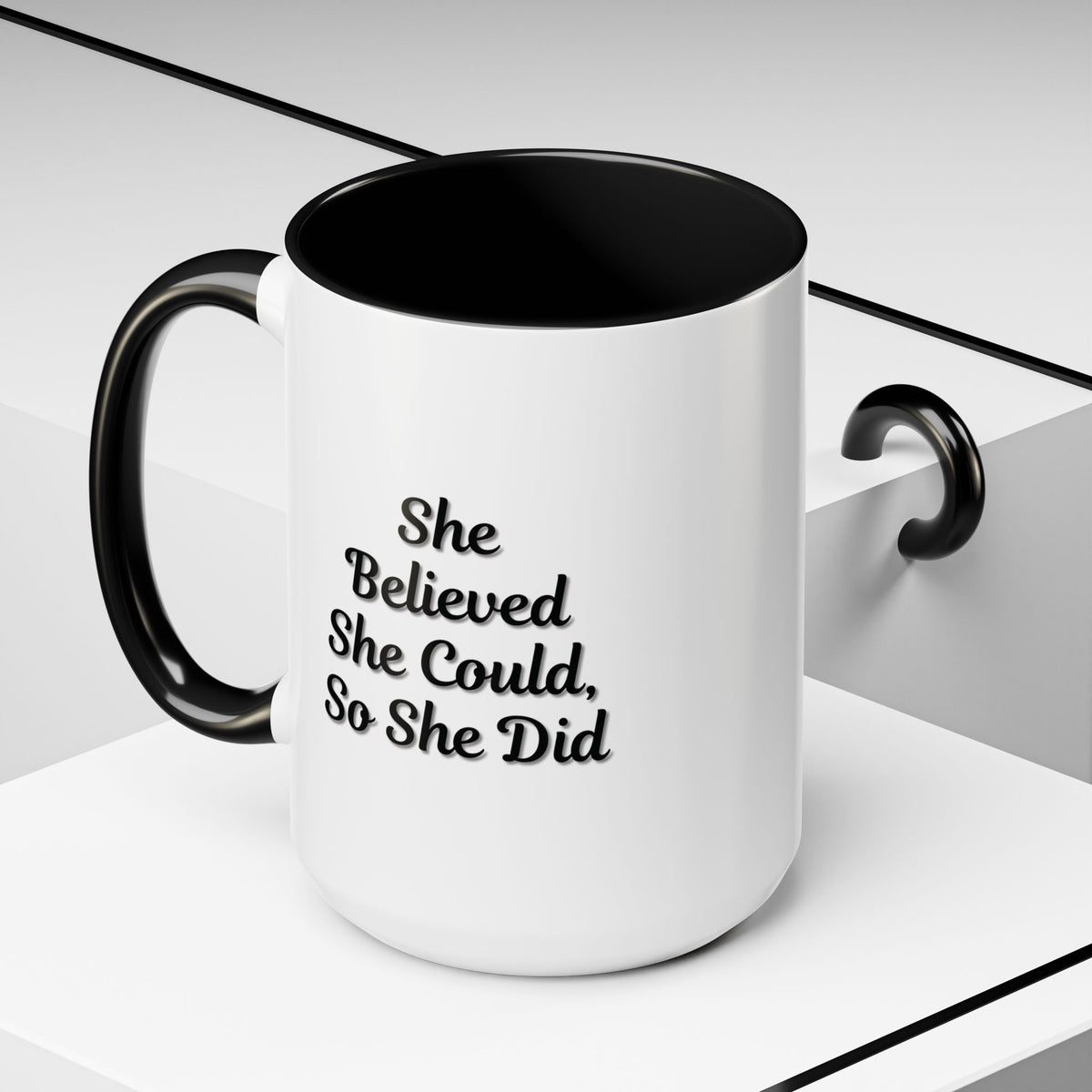 Printify motivational coffee mug with the quote "She Believed She Could, So She Did" featuring a ceramic mug with black lettering.