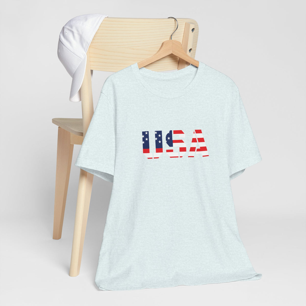 White USA flag text T-shirt by Printify featuring patriotic Fourth of July design and bold American flag graphic.