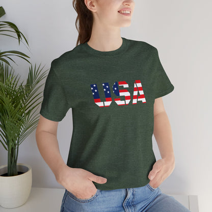 Red, white, and blue USA flag text T-shirt by Printify, featuring patriotic Fourth of July design on a casual T-shirt.