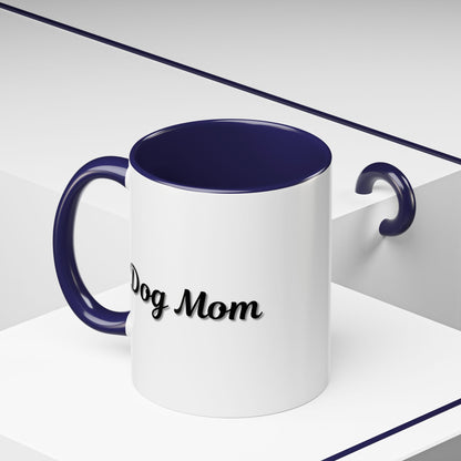 Dog Mom Accent Coffee Mug — white ceramic coffee mug with retro script "Dog Mom" print, colored interior and C-handle, 11oz/15oz, angled view on wooden table