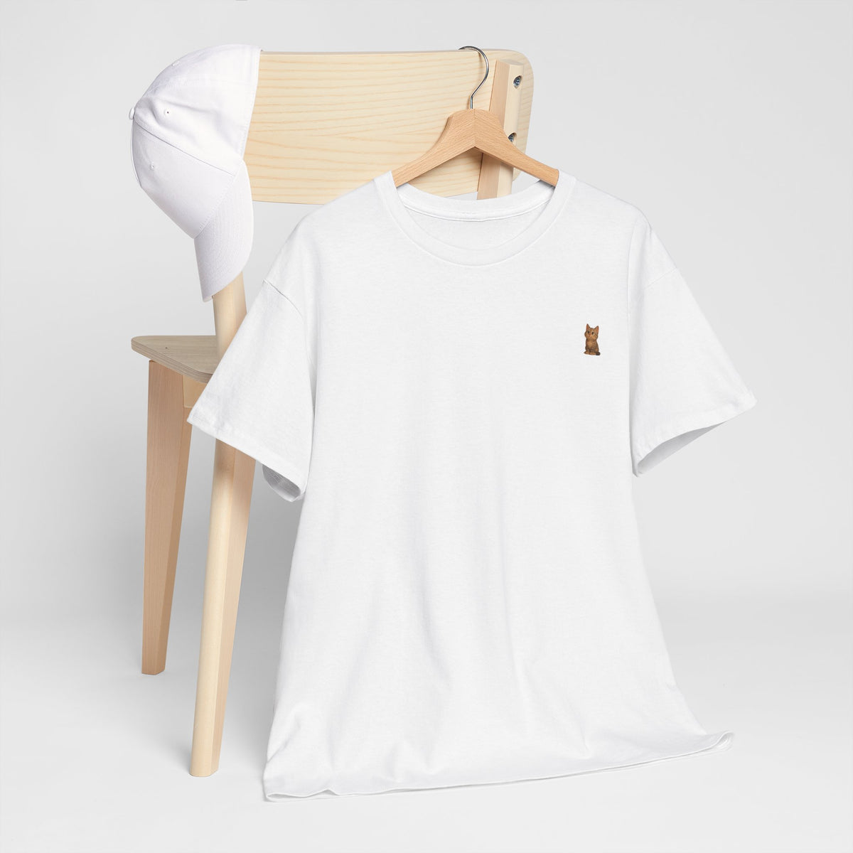Cute brown kitten graphic T-shirt for cat lovers, featuring a playful feline design on a comfortable Printify T-shirt.