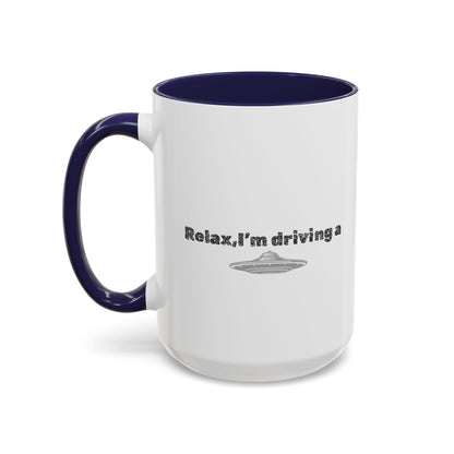 Ceramic coffee mug with "Relax, I’m Driving" UFO accent design, 11 oz, black handle and colorful extraterrestrial graphic.