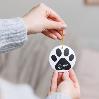 Black paw print ceramic ornament with pet's name, perfect for pet memorial Christmas decoration.