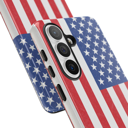 Durable American flag tough phone case for iPhone, featuring patriotic design and protective hard shell by Printify.