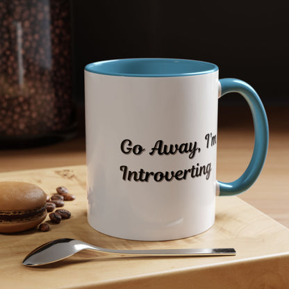 Ceramic coffee mug with "Go Away, I'm Introverting" phrase, 11 oz, white with black lettering, perfect for introverts.