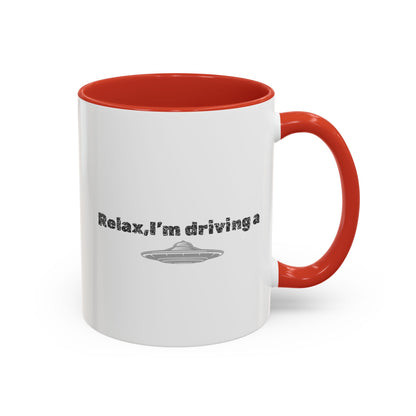 Ceramic coffee mug with UFO accent and "Relax, I’m Driving" text, available in 11 oz and 15 oz sizes.