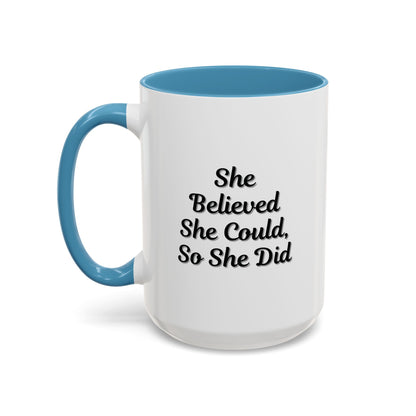 White motivational coffee mug with black text reading "She Believed She Could, So She Did" by Printify, shown from a side angle.
