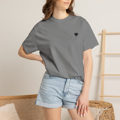 Black T-shirt with minimal heart graphic, featuring a finger heart design, by Printify.