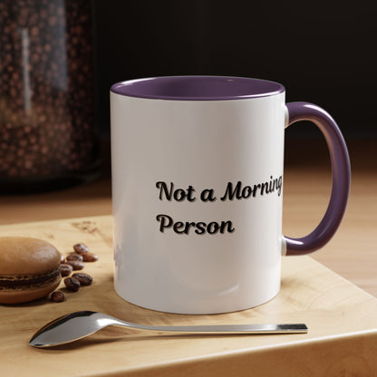 Ceramic coffee mug with "Not a Morning Person" slogan, 11oz or 15oz capacity, in white with black text, by Printify.