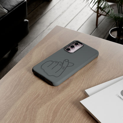 Silicone phone case with embossed Korean finger heart design, compatible with smartphones, by Printify.