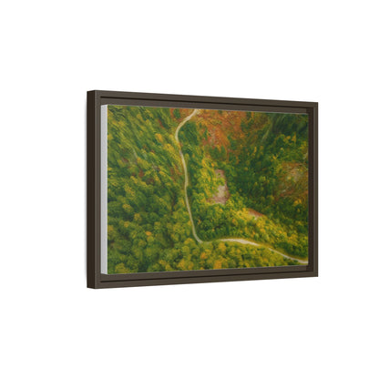 Colorful framed matte canvas wall art featuring an aerial view of a forest path landscape by Printify.