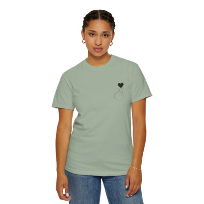 Black T-shirt with a minimal white finger heart graphic, designed for casual wear by Printify.